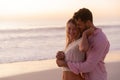 Caucasian couple enjoying time at the beach during the sunset Royalty Free Stock Photo