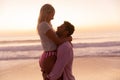 Caucasian couple enjoying time at the beach during the sunset Royalty Free Stock Photo