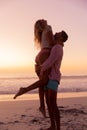 Caucasian couple enjoying time at the beach during the sunset Royalty Free Stock Photo