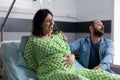 Caucasian couple expecting baby in hospital ward bed Royalty Free Stock Photo