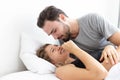 Caucasian couple feeling happy on bed in bedroom