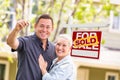 Caucasian Couple in Front of Sold Real Estate Sign and House wit