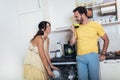 Couple loading dishwasher together in kitchen Royalty Free Stock Photo