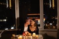 Caucasian couple in love on a date at home with wine and candles, dinner for two on valentine& x27;s day, man woman Royalty Free Stock Photo