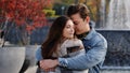 Caucasian couple lovers partners stand background of city fountain pressed closely to cheeks together spend time in Royalty Free Stock Photo