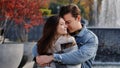 Caucasian couple lovers partners stand background of city fountain pressed closely to cheeks together spend time in Royalty Free Stock Photo