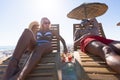 Caucasian couple sitting on deck chairs at the beach Royalty Free Stock Photo
