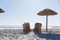 Caucasian couple sitting on deck chairs at the beach Royalty Free Stock Photo