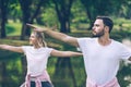 Caucasian couple in sportwear practice Yoga in Public park