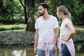 Caucasian couple in sportwear standing together and talking about something happended