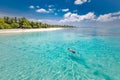Caucasian couple of tourists snorkel in crystal turquoise water near Maldives Island. Perfect weather conditions at luxury resort Royalty Free Stock Photo