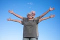 Caucasian couple of two happy senior people enjoying outdoors and nature, standing with open arms feeling freedom. Smiling white- Royalty Free Stock Photo