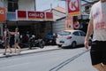 A Caucasian couple walking in front of a local supermarket Royalty Free Stock Photo