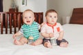 Caucasian cute adorable funny baby boys sitting together on bed Royalty Free Stock Photo