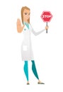 Caucasian doctor holding stop road sign.