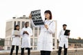 Caucasian doctor holding x-ray scan of patient during break outdoors hospital. Royalty Free Stock Photo