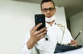 Caucasian Doctor Using Cell Phone gives online consultation. Royalty Free Stock Photo