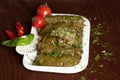 Caucasian dolma is a dish of grape leaves and rice with meat. Serving dolma with yogurt sauce Royalty Free Stock Photo