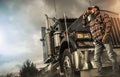 Caucasian Driver Drinking Hot Coffee in Front or His Semi Truck Tractor Royalty Free Stock Photo