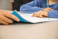 Caucasian elementary school child doing homework at the end of the school day with parental help and support. Royalty Free Stock Photo