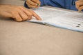 Caucasian elementary school child doing homework at the end of the school day with parental help and support. Royalty Free Stock Photo