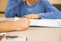 Caucasian elementary school child doing homework at the end of the school day with parental help and support. Royalty Free Stock Photo