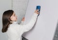 caucasian elementary school Girl is wiping off the white board looking sideways Royalty Free Stock Photo