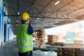 the caucasian engineer using walky talky comunicate with lifting container team with blue sky. Logistics transportation industry