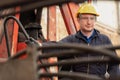 Caucasian engineer at work at container yard and cargo with containers forklift