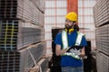 Caucasian engineer inspect steel bars with tablet in a factory