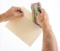 Caucasian ethnicity hands putting fifty dollar bills in envelope