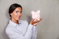 Caucasian ethnicity lady showing piggy bank