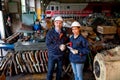 Caucasian factory worker or technician stand and shake hands with Asian factory woman in front of the train and spare part of Royalty Free Stock Photo