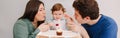 Caucasian family with baby boy celebrating his first birthday at home. Mother father dad with child kid toddler blowing candle on Royalty Free Stock Photo