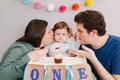 Caucasian family with baby boy celebrating his first birthday at home. Proud parents mother and father dad together with child kid Royalty Free Stock Photo