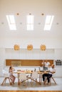 Caucasian family busy together in white kitchen Royalty Free Stock Photo