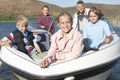 Caucasian Family Of Five In Speedboat