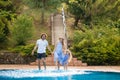 Family having fun their pool. family splashing water with legs or hands in swimming pool Royalty Free Stock Photo