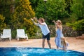 Family having fun their pool. family splashing water with legs or hands in swimming pool Royalty Free Stock Photo