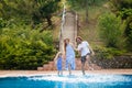 Family having fun their pool. family splashing water with legs or hands in swimming pool Royalty Free Stock Photo