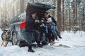 Caucasian family having a good time together in winter forest