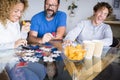 Caucasian family play together on the table at home and have fun laughing a lot - indoor leisure activity and playful time during