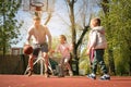 Caucasian family playing basketball together.