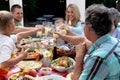 Caucasian family sitting at table during a family lunch in the garden Royalty Free Stock Photo