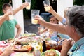 Caucasian family sitting at table during a family lunch in the garden Royalty Free Stock Photo