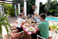 Caucasian family sitting at table during a family lunch in the garden Royalty Free Stock Photo