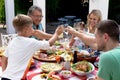 Caucasian family sitting at table during a family lunch in the garden Royalty Free Stock Photo