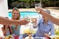 Caucasian family sitting at table during a family lunch in the garden Royalty Free Stock Photo