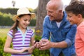 Caucasian family spending time together in the garden, planting Royalty Free Stock Photo