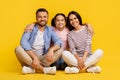 Caucasian family with teen daughter sitting on floor and smiling towards camera Royalty Free Stock Photo